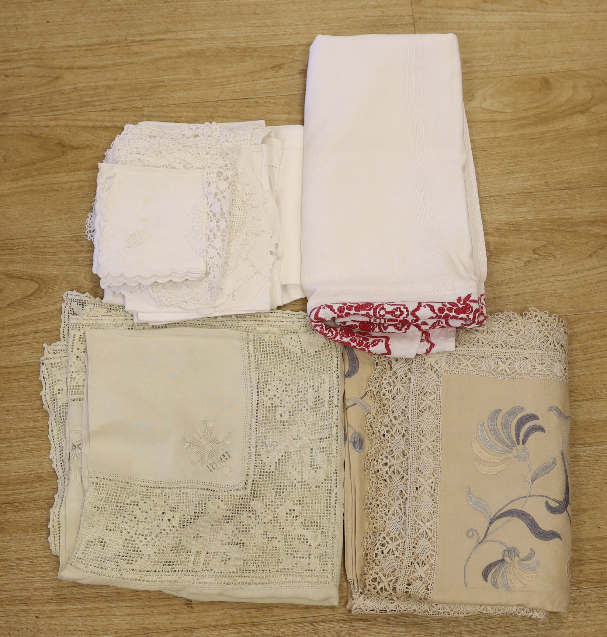 An Edwardian blue embroidered linen table cloth, an Italian embroidered and fillet insertion cloth and various mixed linens